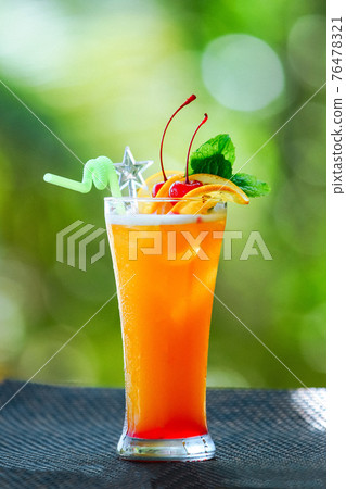 Orange cocktail with cherries, mint and orange slices Orange cocktail with cherries, mint and orange slices 76478321