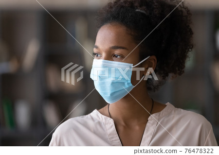 Young biracial woman in facemask look in distance Young biracial woman in facemask look in distance 76478322