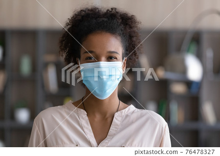 Portrait of smiling African American woman in facemask Portrait of smiling African American woman in facemask 76478327