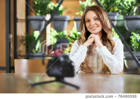Smiling woman preparing for interview on camera. Smiling woman preparing for interview on camera. 76480098