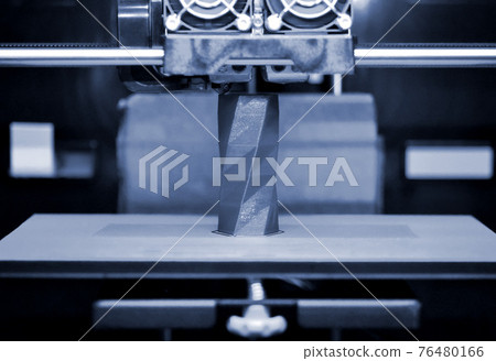3D printer works and creates an object from the hot molten plastic 76480166