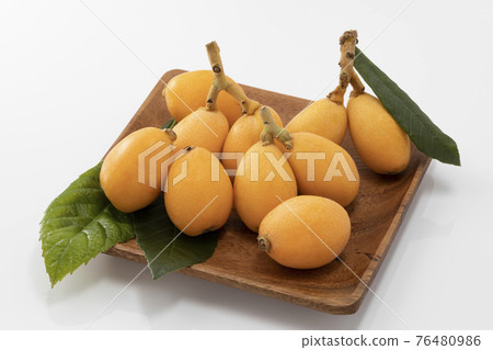 Loquat with leaves on a white background Loquat with leaves on a white background 76480986