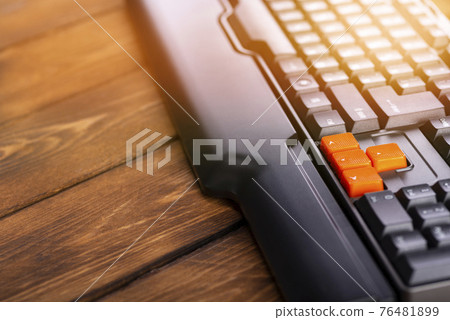 Orange arrow keys on a black keyboard, up, down, left, right buttons on a gaming computer keyboard 76481899