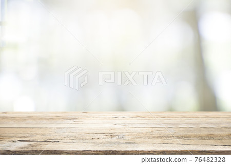 Empty wooden table for present product on coffee shop blur background. 76482328