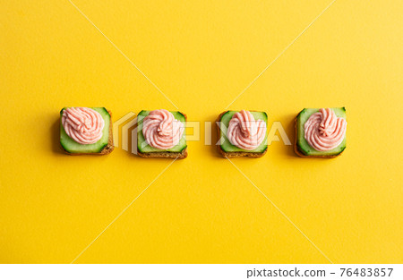 Canape with tarama on the yellow background Canape with tarama on the yellow background 76483857