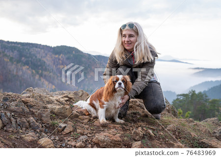 Woman and cavalier king charles spaniel 76483969