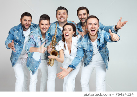happy men and woman in denim t-shirt jeans on studio background. happy men and woman in denim t-shirt jeans on studio background. 76484124