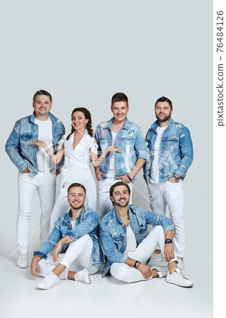 happy men and woman in denim t-shirt jeans on studio background. 76484126