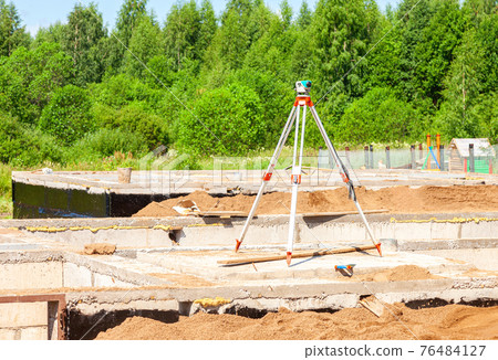 Geodetic equipment optical level at the construction site Geodetic equipment optical level at the construction site 76484127