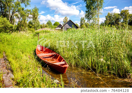 Summer landscape with red wooden fishing boat Summer landscape with red wooden fishing boat 76484128