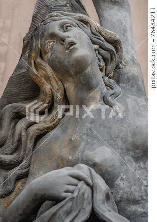 Facade statue of sensual Rococo Era woman at New Palace in Potsdam, Germany, details, closeup 76484211