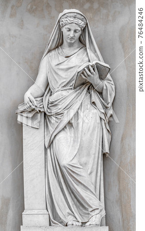 Ancient statue of sensual Italian Renaissance Era woman reading a book, Potsdam, Germany, details, closeup 76484246