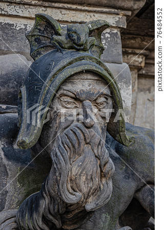 Very old statute of scary gatekeeper, medieval warrior with weapon in historical downtown of Dresden, Germany Very old statute of scary gatekeeper, medieval warrior with weapon in historical downtown of Dresden, Germany 76484552