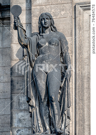 Old wall statue made of black stone of a naked woman with mirror in front of Supreme Land Court (Oberlandesgericht) palace in Dresden, Germany 76484578