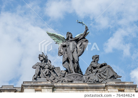 Old statue of a black angel as a warrior with green wings at the roof top of the central historical building of Albertinum museum in downtown of Dresden, Germany 76484624