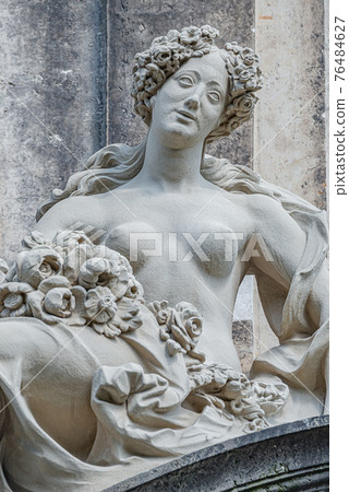 Old statue of a sensual Baroque Era naked woman in downtown of Dresden, Germany, details, closeup 76484627