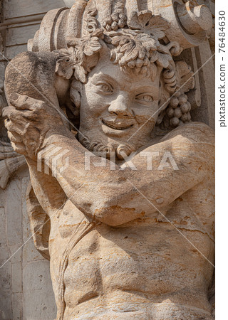 Old sculpture of funny and joyful dickens in downtown of Dresden, Germany, details, closeup 76484630