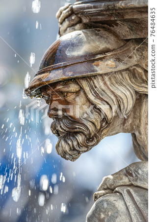 Ancient statute of an old bearded man as a telamon and medieval warrior of a fountain in historical downtown of Dresden, Germany, details, closeup Ancient statute of an old bearded man as a telamon and medieval warrior of a fountain in historical downtown of Dresden, Germany, details, closeup 76484635