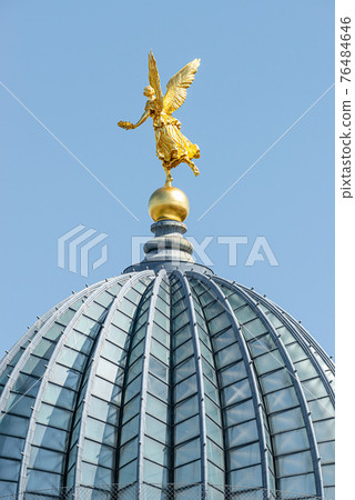 Old statue of a golden angel as a warrior and defender at the dome top of the central historical building Zitronenpresse in downtown of Dresden, Germany, details 76484646