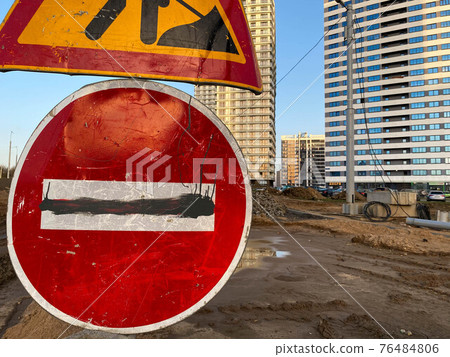 A large red stop road sign for road repairs and asphalt paving A large red stop road sign for road repairs and asphalt paving 76484806