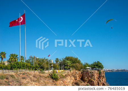Bird view of Antalya and Mediterranean seacoast and beach with a paraglider and Turkish flag, Antalya, Turkey, 76485019