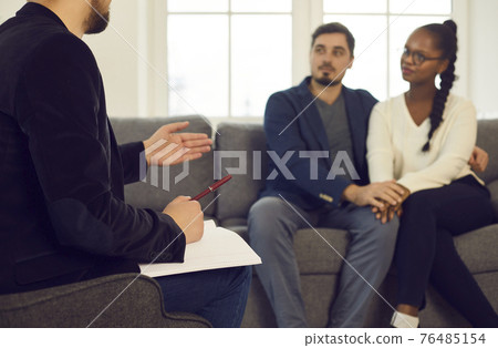 Unfocused couple listening family consultant giving advice to solve problem Unfocused couple listening family consultant giving advice to solve problem 76485154