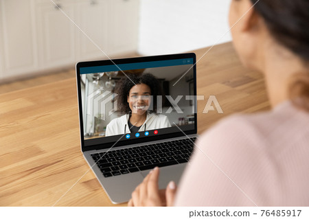 Young black woman answer friend by video call on pc Young black woman answer friend by video call on pc 76485917
