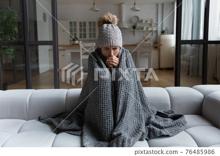 Latina female shiver at freezing flat in warm cap blanket 76485986