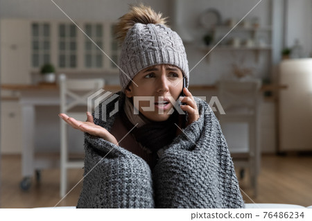 Young woman tenant call apartment management company complain on cold 76486234