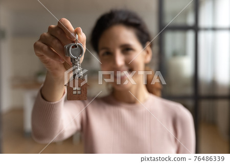 Hispanic female happy homeowner look at camera celebrate getting mortgage Hispanic female happy homeowner look at camera celebrate getting mortgage 76486339