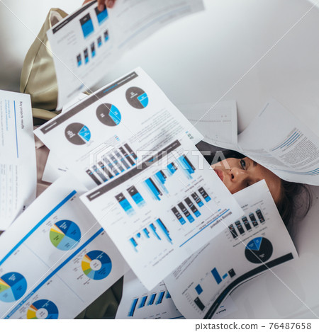 Woman is swamped with paperwork. Work, business 76487658