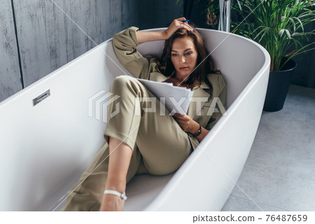 Woman locked herself in the bathroom to work with documents. Work from home 76487659