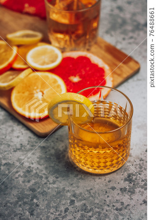 Citrus cocktail in a whiskey glass with lemons and grapefruit 76488661