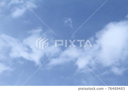 Beautiful blue sky and white clouds of various shapes with sunlight Nature background 76489483