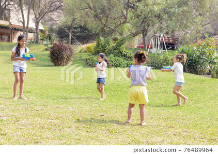 Little girls playing with water in the summer Little girls playing with water in the summer 76489964
