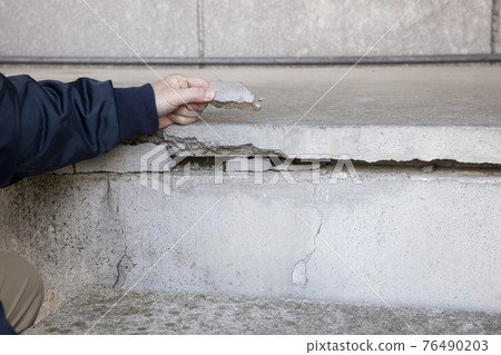 Large cracks and debris in building foundations 76490203