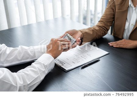 Businesspeople transfer of bribe money to his partner, corruption concepts. 76492995