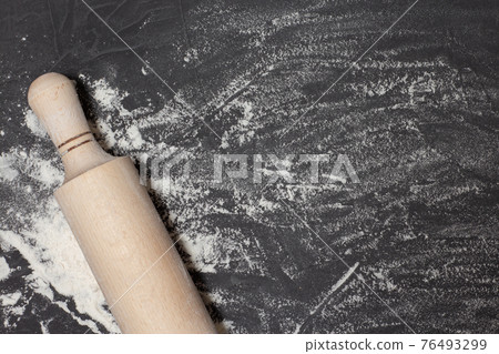 Rolling pin and white flour on black stone table. Banner for web with free space for your text. Concept for bakery shop. Top view, copy space Rolling pin and white flour on black stone table. Banner for web with free space for your text. Concept for bakery shop. Top view, copy space 76493299