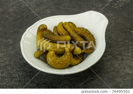 Pickled gherkin in the bowl 76495502