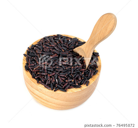 dark violet rice berry with wooden bowl and spoon isolated on white background 76495872