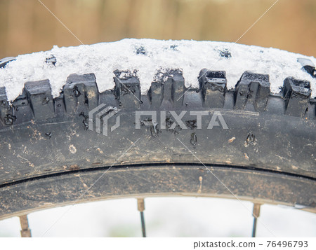 Rear mtb wheel with fat tire for extreme terrain. Close up of a tire Rear mtb wheel with fat tire for extreme terrain. Close up of a tire 76496793
