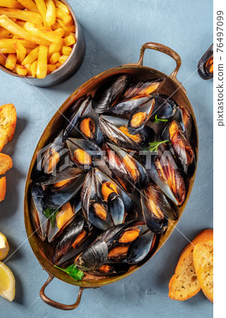 Moules frites, Belgian mussels with French fries Moules frites, Belgian mussels with French fries 76497099