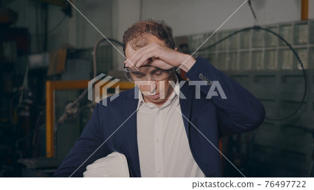 businessman in suits safety hats and goggles tired worker stand remove your safety hat and wipe off bait 76497722