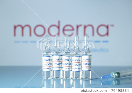 Moderna vaccine against COVID-19. Glass medical vials with liquid on the background Moderna company logo. Ampoules with coronavirus vaccine on a medical glass table Moderna vaccine against COVID-19. Glass medical vials with liquid on the background Moderna company logo. Ampoules with coronavirus vaccine on a medical glass table 76498884