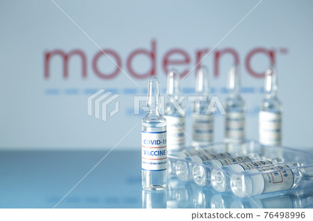 Moderna vaccine against COVID-19. Glass medical vials with liquid on the background Moderna company logo. Ampoules with coronavirus vaccine on a medical glass table Moderna vaccine against COVID-19. Glass medical vials with liquid on the background Moderna company logo. Ampoules with coronavirus vaccine on a medical glass table 76498996