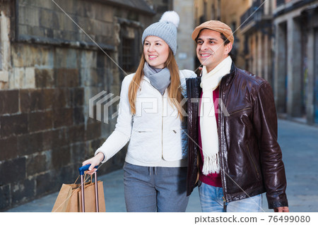 male and female in the historic center with baggage male and female in the historic center with baggage 76499080