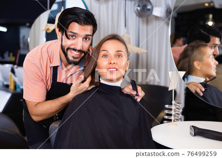 Male professional with female talking about hairstyle Male professional with female talking about hairstyle 76499259