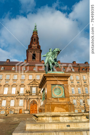Christiansborg Palace and statue of Christian IX illuminated in early morning, Copenhagen, Denmark 76499395