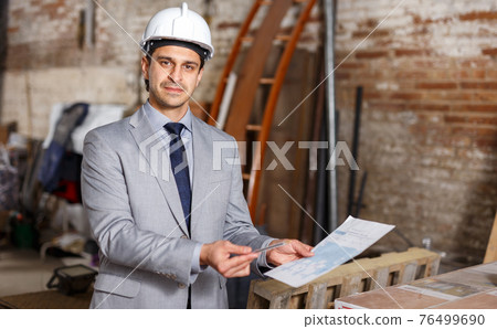 Friendly man holding paper Friendly man holding paper 76499690