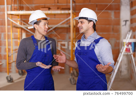 Portrait of two confident workers Portrait of two confident workers 76499700